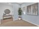 Cozy bedroom featuring neutral carpet, light blue walls, and views into the entryway at 21934 E Lords Ct, Queen Creek, AZ 85142
