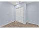 Simple bedroom with neutral carpet, light blue walls, and a double closet with sliding doors at 21934 E Lords Ct, Queen Creek, AZ 85142