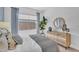 Stylish bedroom with a large window, decor, and neutral furniture at 21934 E Lords Ct, Queen Creek, AZ 85142