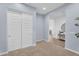 Clean bedroom with double closets, neutral carpet, and light blue walls at 21934 E Lords Ct, Queen Creek, AZ 85142