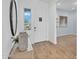 Bright foyer featuring hardwood flooring, natural light, and a decorative table against a white wall at 21934 E Lords Ct, Queen Creek, AZ 85142