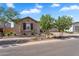 Attractive single-story home showcasing stone accents, desert landscaping and a well-maintained lawn at 21934 E Lords Ct, Queen Creek, AZ 85142