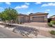Charming home featuring a three car garage, a brick driveway, and desert landscaping at 21934 E Lords Ct, Queen Creek, AZ 85142