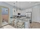 Modern kitchen with an island and barstool seating, stainless steel appliances, granite counters, and ample cabinet space at 21934 E Lords Ct, Queen Creek, AZ 85142
