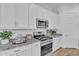 Well-equipped kitchen with granite countertops, stainless steel appliances, white cabinets, and ample storage space at 21934 E Lords Ct, Queen Creek, AZ 85142
