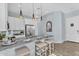 Bright kitchen features white cabinets, granite countertops, stainless steel appliances, and modern pendant lighting at 21934 E Lords Ct, Queen Creek, AZ 85142