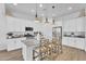 Open concept kitchen with white cabinets, stainless steel appliances, granite countertops, and a central island with seating at 21934 E Lords Ct, Queen Creek, AZ 85142