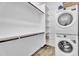 Functional laundry room with washer, dryer, storage shelves, and wood-look flooring at 21934 E Lords Ct, Queen Creek, AZ 85142