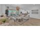 Spacious living area with an open floor plan, stylish furnishings, and sliding glass doors leading to an outdoor space at 21934 E Lords Ct, Queen Creek, AZ 85142