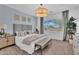 Inviting bedroom featuring a plush bed, neutral tones, and large window with natural light at 21934 E Lords Ct, Queen Creek, AZ 85142