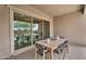 Covered patio with outdoor dining set and sliding glass doors leading to interior spaces at 21934 E Lords Ct, Queen Creek, AZ 85142