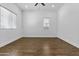 Bedroom featuring lots of natural light, wood-look floors, and a contemporary ceiling fan at 21973 N 102Nd Ln # 411, Peoria, AZ 85383
