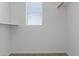 Walk-in closet with a window providing natural light and ample storage space at 21973 N 102Nd Ln # 411, Peoria, AZ 85383
