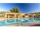Beautiful community pool area with covered seating, ideal for enjoying the outdoors at 21973 N 102Nd Ln # 411, Peoria, AZ 85383