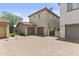 Exterior view of a two-story home with a two-car garage and brick paved driveway at 21973 N 102Nd Ln # 411, Peoria, AZ 85383