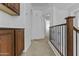 Upstairs hallway with built-in cabinetry and access to bedrooms at 21973 N 102Nd Ln # 411, Peoria, AZ 85383