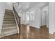 Spacious living room featuring wood-look flooring, staircase, and ample natural light at 21973 N 102Nd Ln # 411, Peoria, AZ 85383