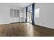 Open living space with custom built-ins, hardwood floors, and sliding glass doors at 21973 N 102Nd Ln # 411, Peoria, AZ 85383