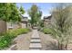 Stone path and desert landscaping between homes creates a serene outdoor experience at 21973 N 102Nd Ln # 411, Peoria, AZ 85383
