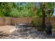 Secluded backyard area with a gravel seating section and a patio set perfect for outdoor relaxation and entertaining guests at 2243 E Cortez Dr, Gilbert, AZ 85234