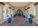 Elegant clubhouse entrance with stone flooring, columns, and blue potted plants at 2243 E Cortez Dr, Gilbert, AZ 85234