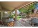 This spacious covered patio showcases an outdoor dining set and views of the meticulously kept backyard and landscaped area at 2243 E Cortez Dr, Gilbert, AZ 85234