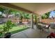 The covered patio overlooks a well-maintained yard with lush landscaping, offering an ideal outdoor dining and lounging area at 2243 E Cortez Dr, Gilbert, AZ 85234