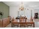 Inviting dining room with wood table, chairs, chandelier, and large window with plantation shutters at 2243 E Cortez Dr, Gilbert, AZ 85234