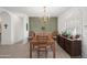 Bright dining room featuring a wood table, chairs, chandelier, and view into other rooms at 2243 E Cortez Dr, Gilbert, AZ 85234