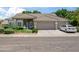 Charming single-story home featuring a tile roof, three-car garage, and manicured front yard at 2243 E Cortez Dr, Gilbert, AZ 85234