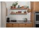 Stylish kitchen featuring custom cabinets, elegant countertops, and decorative shelving at 2243 E Cortez Dr, Gilbert, AZ 85234