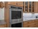 Modern kitchen with built-in stainless steel double oven and light wood cabinetry at 2243 E Cortez Dr, Gilbert, AZ 85234