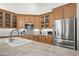 Spacious kitchen with stainless steel appliances, countertops, sink, and wooden cabinetry at 2243 E Cortez Dr, Gilbert, AZ 85234