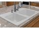 A clean, double basin white kitchen sink with a modern faucet and soap dispenser at 2243 E Cortez Dr, Gilbert, AZ 85234
