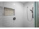 Close up of the tiled shower with decorative accent and shower head fixture at 2243 E Cortez Dr, Gilbert, AZ 85234