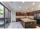 Modern kitchen boasts stainless steel appliances, granite counters, and an island with a sink at 2275 N Heritage St, Buckeye, AZ 85396