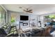 Bright living room with large windows, wood floors, and modern entertainment center at 2275 N Heritage St, Buckeye, AZ 85396