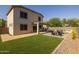 Lush backyard featuring a fire pit, outdoor kitchen and artificial grass at 2661 E Los Alamos Ct, Gilbert, AZ 85295