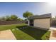 Lush artificial grass and a stylish shed highlight the backyard, creating a serene and inviting outdoor space at 2661 E Los Alamos Ct, Gilbert, AZ 85295