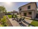Lush backyard featuring a fire pit, shed, and artificial grass for year-round enjoyment at 2661 E Los Alamos Ct, Gilbert, AZ 85295