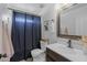Bathroom featuring a dark shower curtain, vanity, mirror, and coordinated decor at 2661 E Los Alamos Ct, Gilbert, AZ 85295