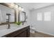 Well-lit bathroom with a double sink vanity, elegant mirrors, a separate toilet area, and modern fixtures for added convenience at 2661 E Los Alamos Ct, Gilbert, AZ 85295