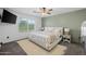 Bright bedroom featuring a neutral color scheme, ceiling fan, and a large window for natural light at 2661 E Los Alamos Ct, Gilbert, AZ 85295