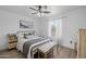 Well-lit bedroom featuring a metal bedframe, wood floors, bench and soft, natural lighting at 2661 E Los Alamos Ct, Gilbert, AZ 85295