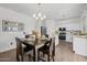 Inviting dining area with wood flooring, a stylish light fixture, and seamlessly connecting the kitchen at 2661 E Los Alamos Ct, Gilbert, AZ 85295