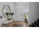 Inviting foyer with tile flooring, a round mirror, and neutral decor, leading to the staircase at 2661 E Los Alamos Ct, Gilbert, AZ 85295