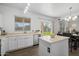 Bright open kitchen with an island, wood-look flooring, and a view of the backyard at 2661 E Los Alamos Ct, Gilbert, AZ 85295