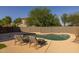 Relaxing pool with desert landscaping, comfortable lounge chairs, and a serene atmosphere in the backyard at 2661 E Los Alamos Ct, Gilbert, AZ 85295