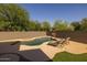 Private backyard pool with a waterfall feature, desert landscaping, and lounge chairs for relaxing at 2661 E Los Alamos Ct, Gilbert, AZ 85295