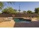 Enjoy this backyard pool with desert landscaping, a soothing waterfall, and a relaxing lounge area at 2661 E Los Alamos Ct, Gilbert, AZ 85295